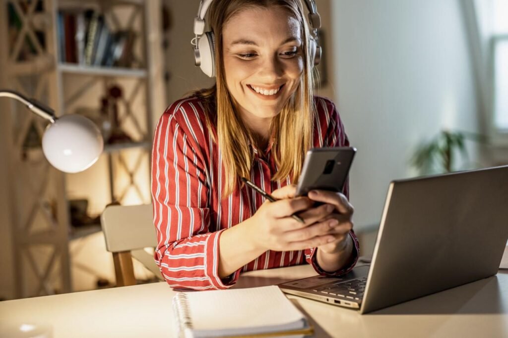 girl relaxing on laptop with headphones